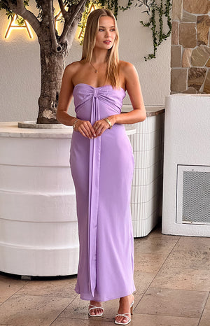 Girl wearing purple maxi dress and white heels with gold jewellery.