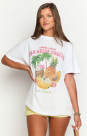 a white t-shirt with a tropical print is worn by a girl with jean shorts and a gold bracelet