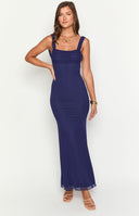 blonde model wearing a navy blue mesh formal maxi dress styles with gold bracelets and a gold flower necklace