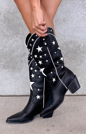 model wearing black pu leather cowboy boots with contrast white star details