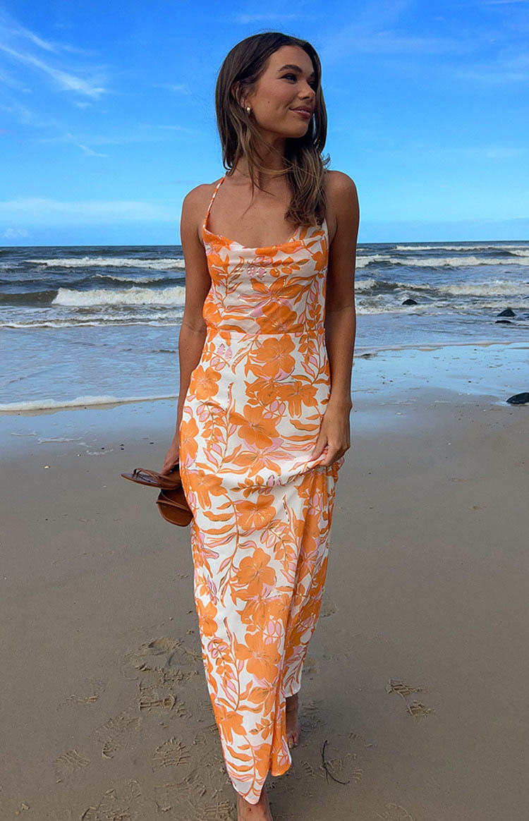 Orange floral print maxi dress on brunette model