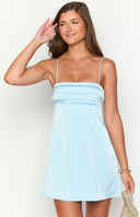 blonde model wearing a baby blue satin mini dress with pleat details at the bust paired with gold jewellery