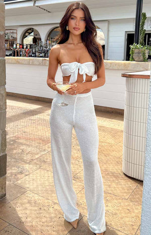 White sequin high waist pants on brunette model.