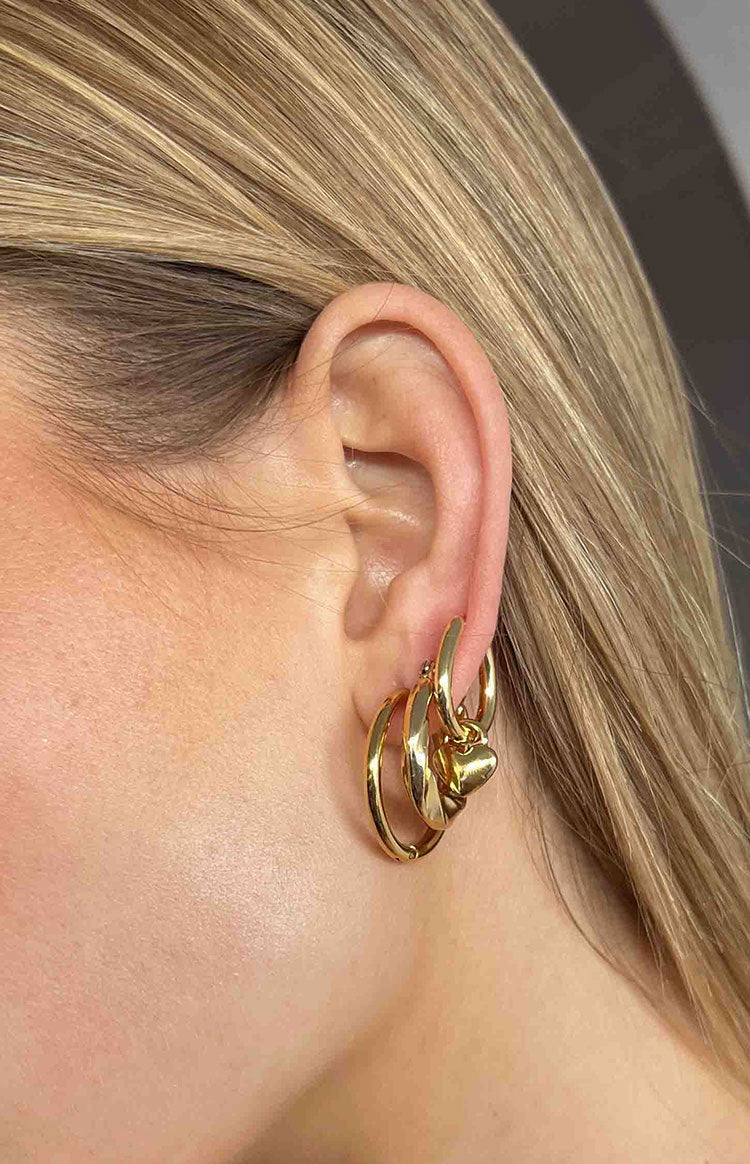 Close up of blonde girl wearing the Harpie Gold Hoop Earrings.