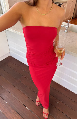 Girl wearing red maxi dress and red heels holding wine glass