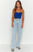 Light blue uneven waist denim jeans with raw hem.