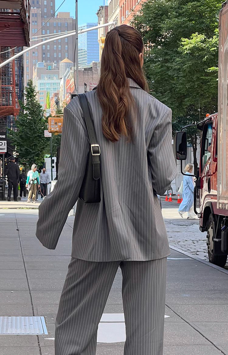 Girl facing away wearing striped blazer and matching pants