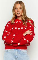 Red knit sweater with horizontal white heart detailing