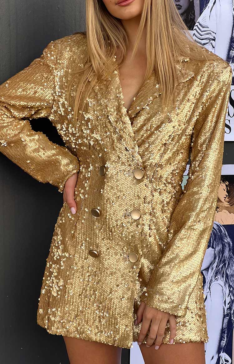 Close up details of gold sequin blazer mini dress.