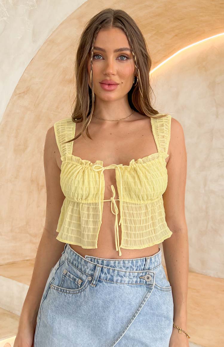 Belle Lucia model in yellow crop top.