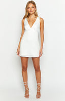 White mini dress with minimal detailing and under bust seams on model