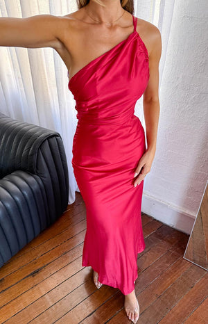 blonde girl wearing a red satin one shoulder formal dress with clear heels and delicate gold jewellery