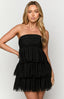 Black strapless tiered mini dress styled on brunette model.