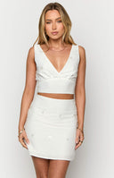 White v-neck style crop top with embellishments on Crystal Bellotti