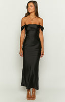 Tall brunette model is photographed wearing an off the shoulder black maxi formal dress