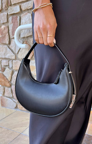 Close up of girl holding the ellisa black shoulder bag.