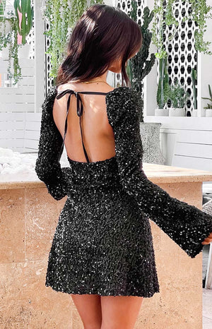 Black sequin long sleeve velvet mini dress on brunette model 