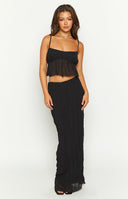 full length shot of blonde model in black maxi skirt with matching cami top